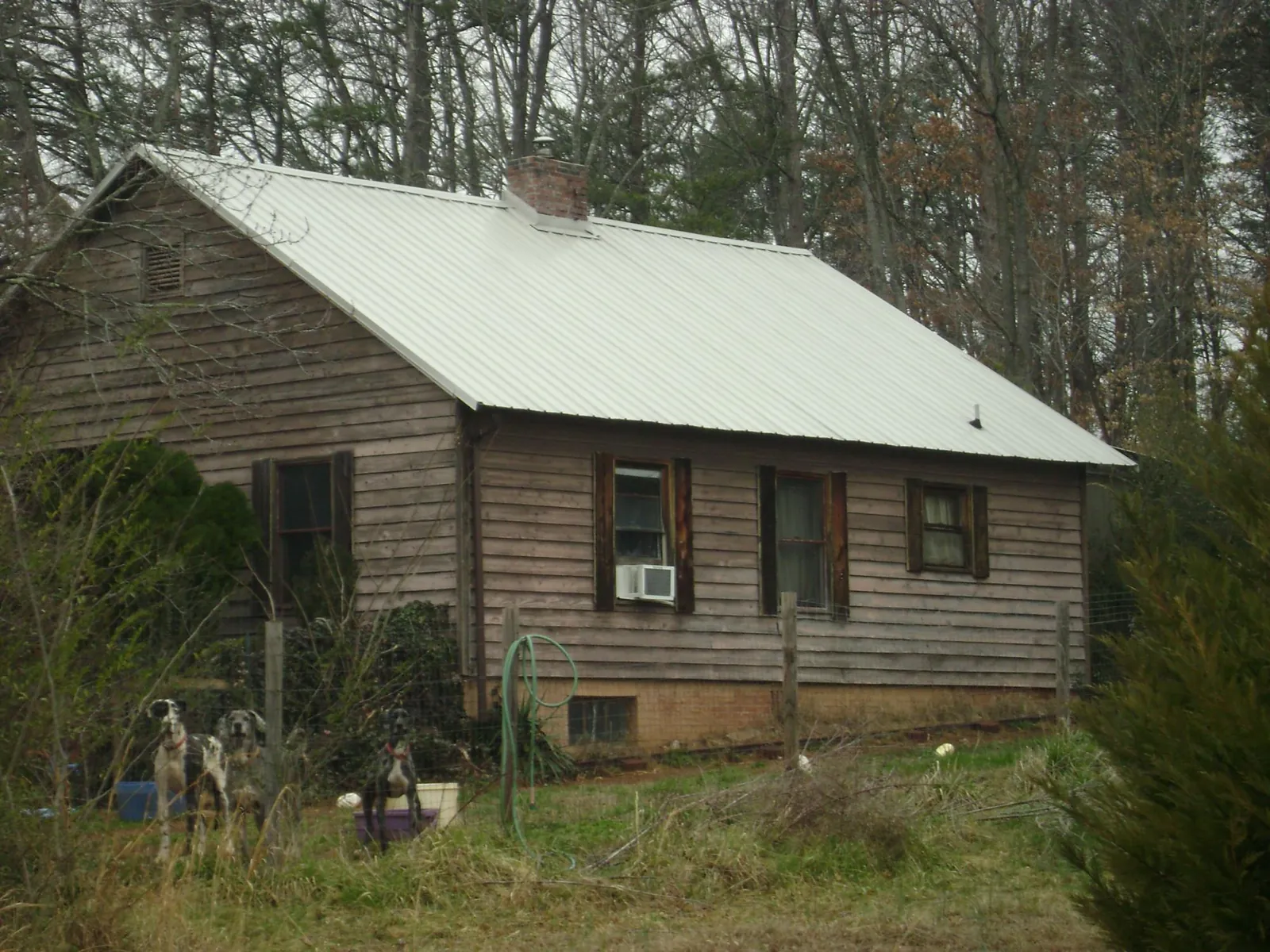 White metal roof on an old wood sided farmhouse, from a Metal Roof Installation job in North Street